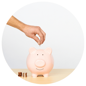 hand depositing money into piggy bank
