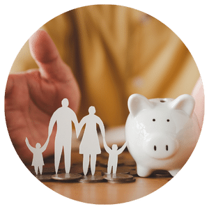 paper family next to piggy bank in between a person's hands